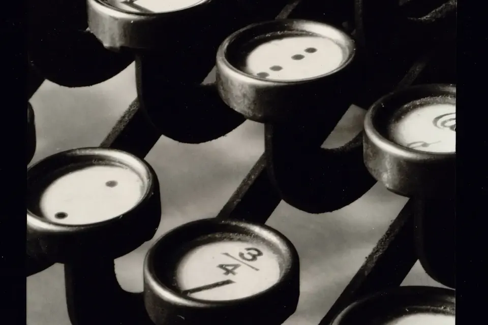 Close-up black-and-white photograph of round typewriter keys arranged in staggered rows